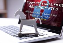 The Danger of RATs trojan horse in front of laptop screen with message your personal files are encrypted