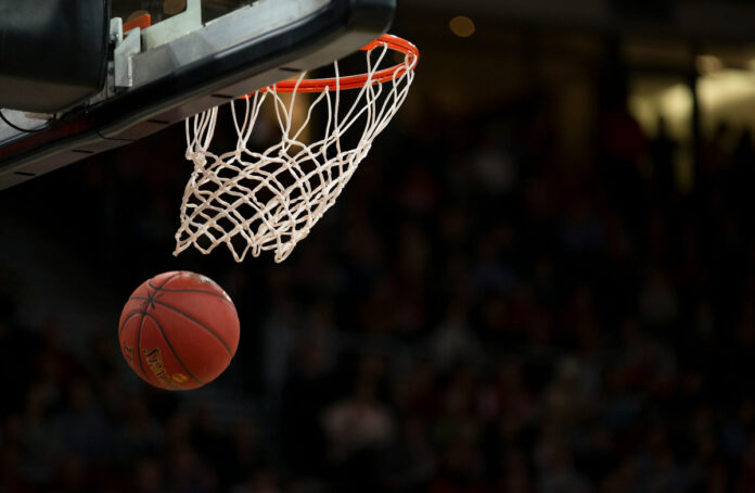 A basketball swishing through a basketball hoop.